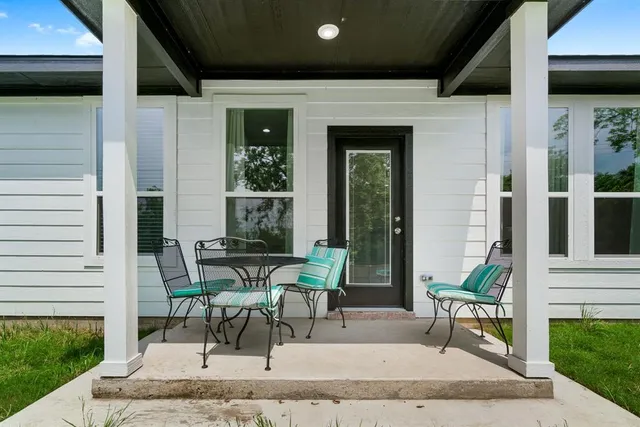 a building outdoor space with patio furniture and potted plants