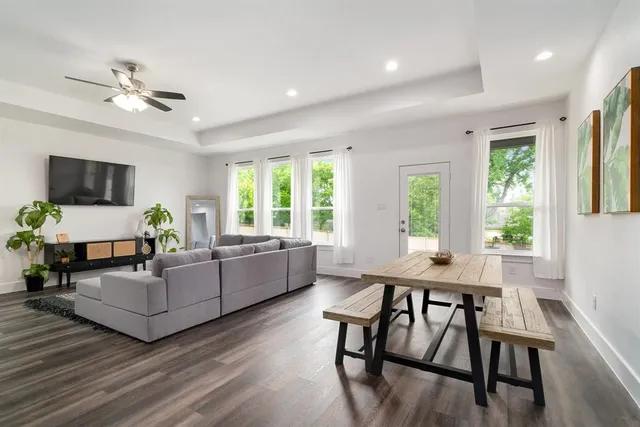 a living room with furniture and a wooden floor