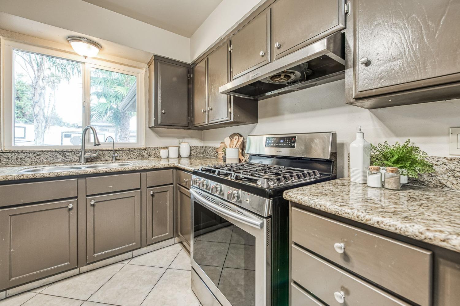 2866 Caesar Avenue Clovis, CA 93612 - Photo 12 of 45 a kitchen with granite countertop a sink stainless steel appliances and cabinets