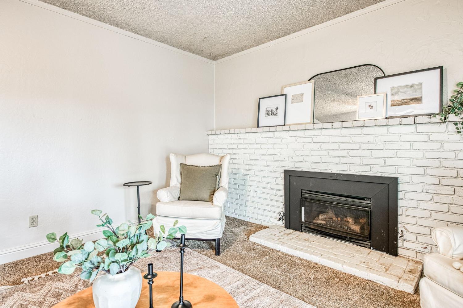 2866 Caesar Avenue Clovis, CA 93612 - Photo 17 of 45 a living room with furniture and a fireplace