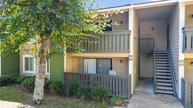 a front view of a house with plants