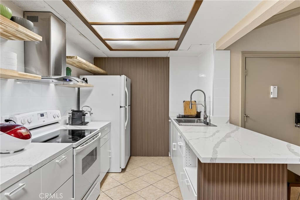 3535 Banbury Drive, Unit 14 Riverside, CA 92505 - Photo 22 of 26 a kitchen with stainless steel appliances granite countertop a sink stove and refrigerator