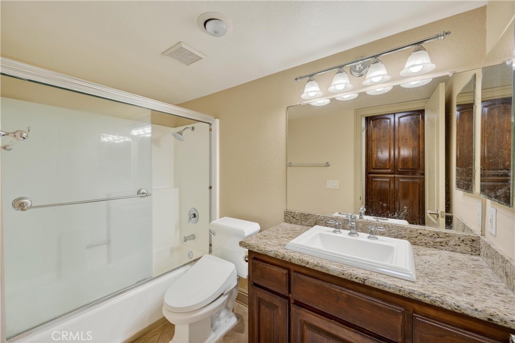 3535 Banbury Drive, Unit 14 Riverside, CA 92505 - Photo 10 of 26 a bathroom with a granite countertop sink toilet and shower