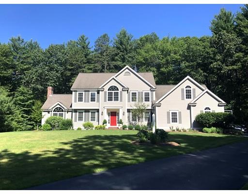 265 Sargent Road Boxborough, MA 01719 - Photo 1 of 15 a view of a white house with a big yard and potted plants in front of it
