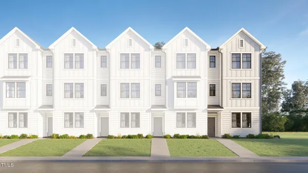 front view of a residential apartment building with a yard
