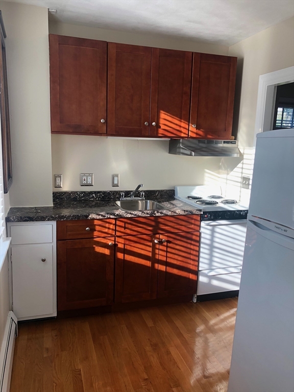 28 Darling Street, Unit 3 Marblehead, MA 01945 - Photo 2 of 8 a kitchen with granite countertop stainless steel appliances and cabinets