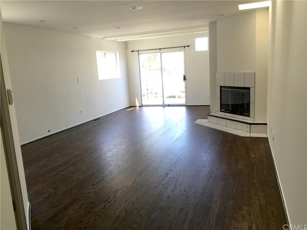3401 Pine Avenue Manhattan Beach, CA 90266 - Photo 14 of 24 an empty room with wooden floor and a fireplace
