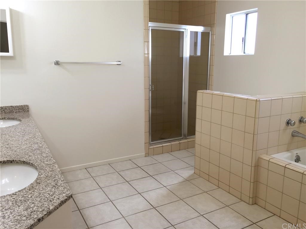 3401 Pine Avenue Manhattan Beach, CA 90266 - Photo 16 of 24 a bathroom with a granite countertop sink and a mirror