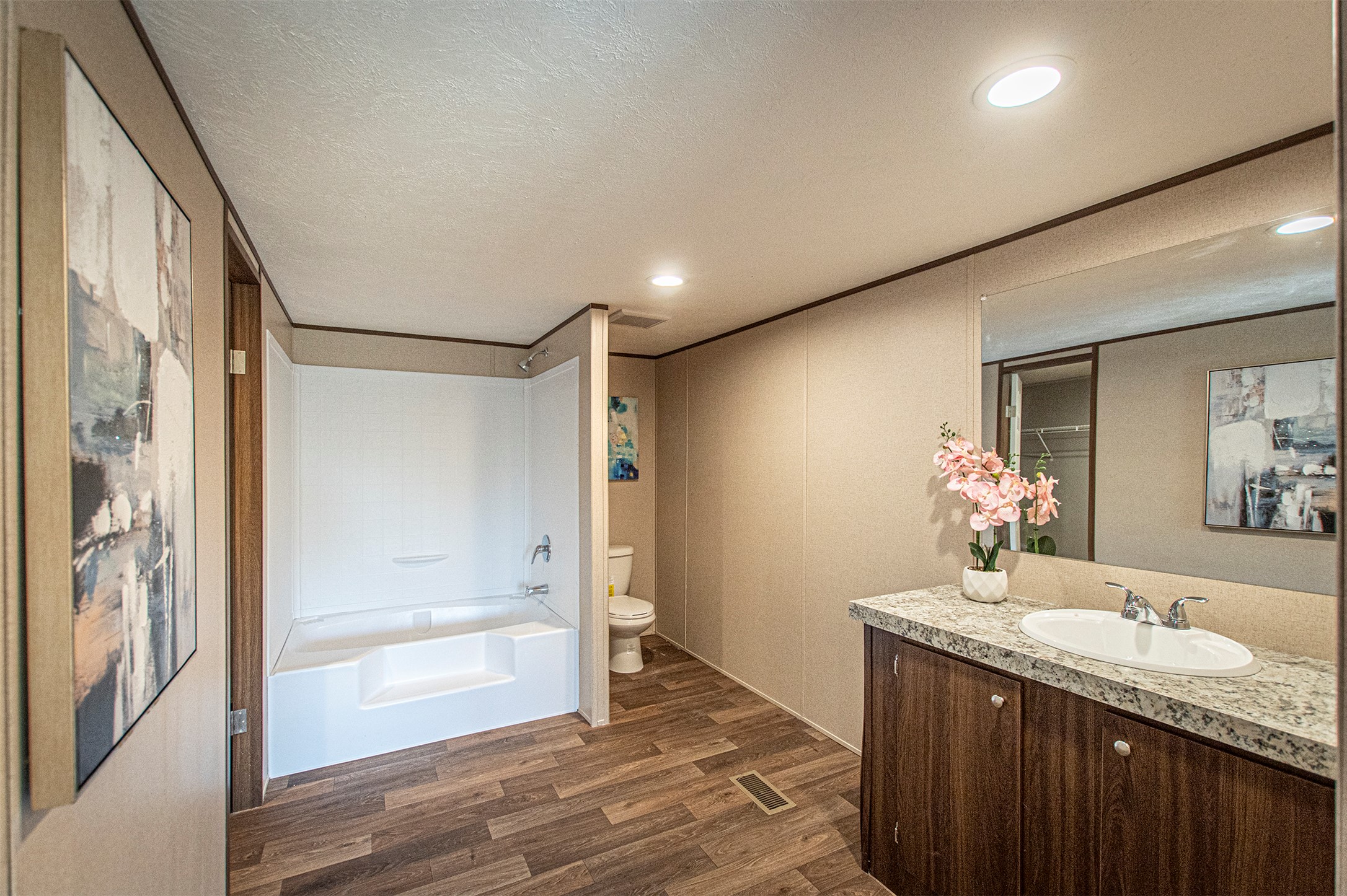 135 Spanish Oak Road Dale, TX 78616 - Photo 15 of 30 a bathroom with a granite countertop sink a mirror and a shower