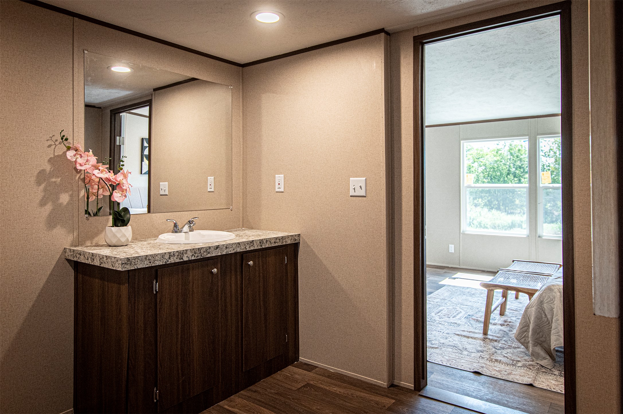135 Spanish Oak Road Dale, TX 78616 - Photo 16 of 30 a bathroom with a granite countertop sink and a mirror