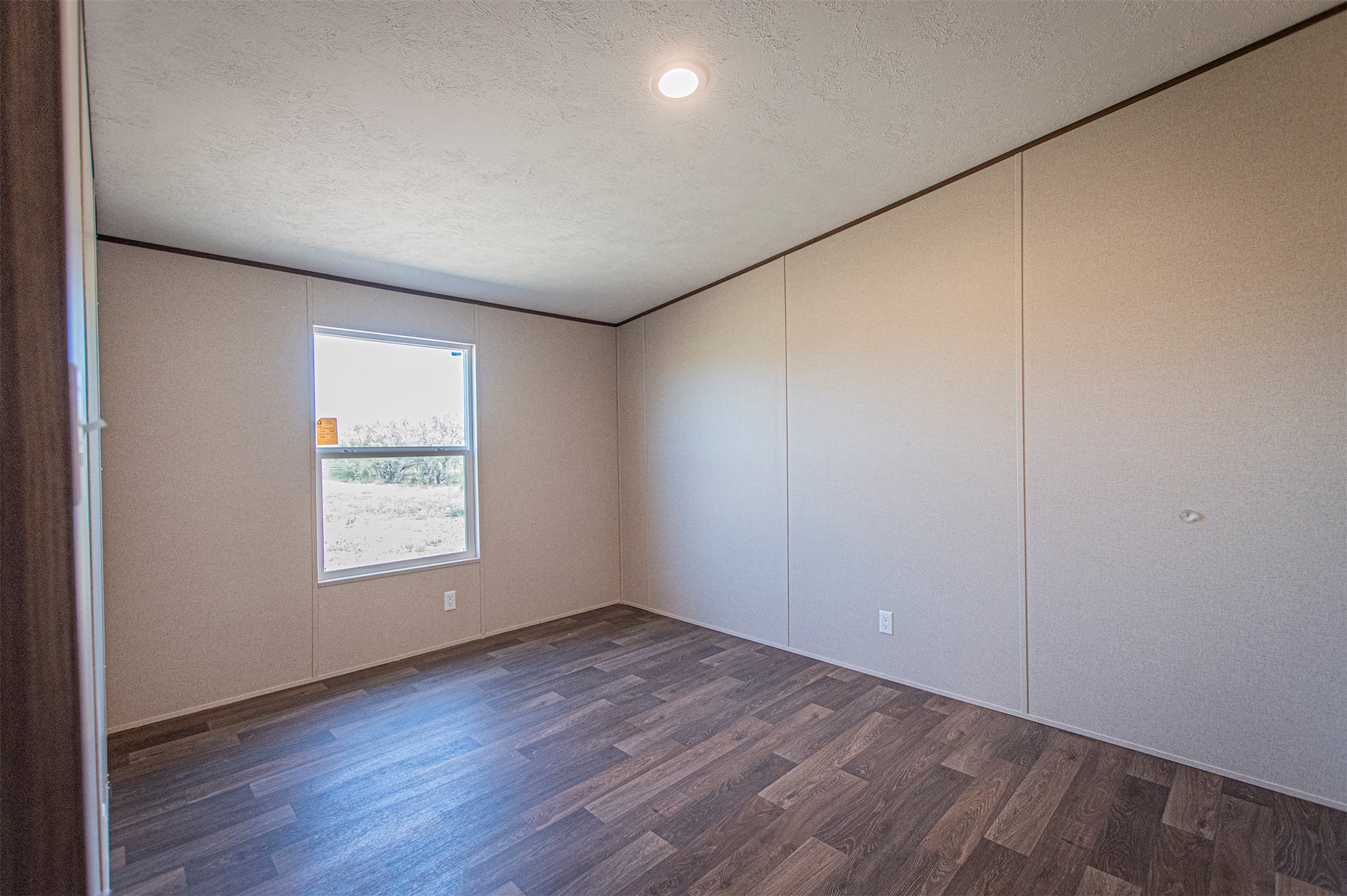135 Spanish Oak Road Dale, TX 78616 - Photo 17 of 30 an empty room with wooden floor and windows