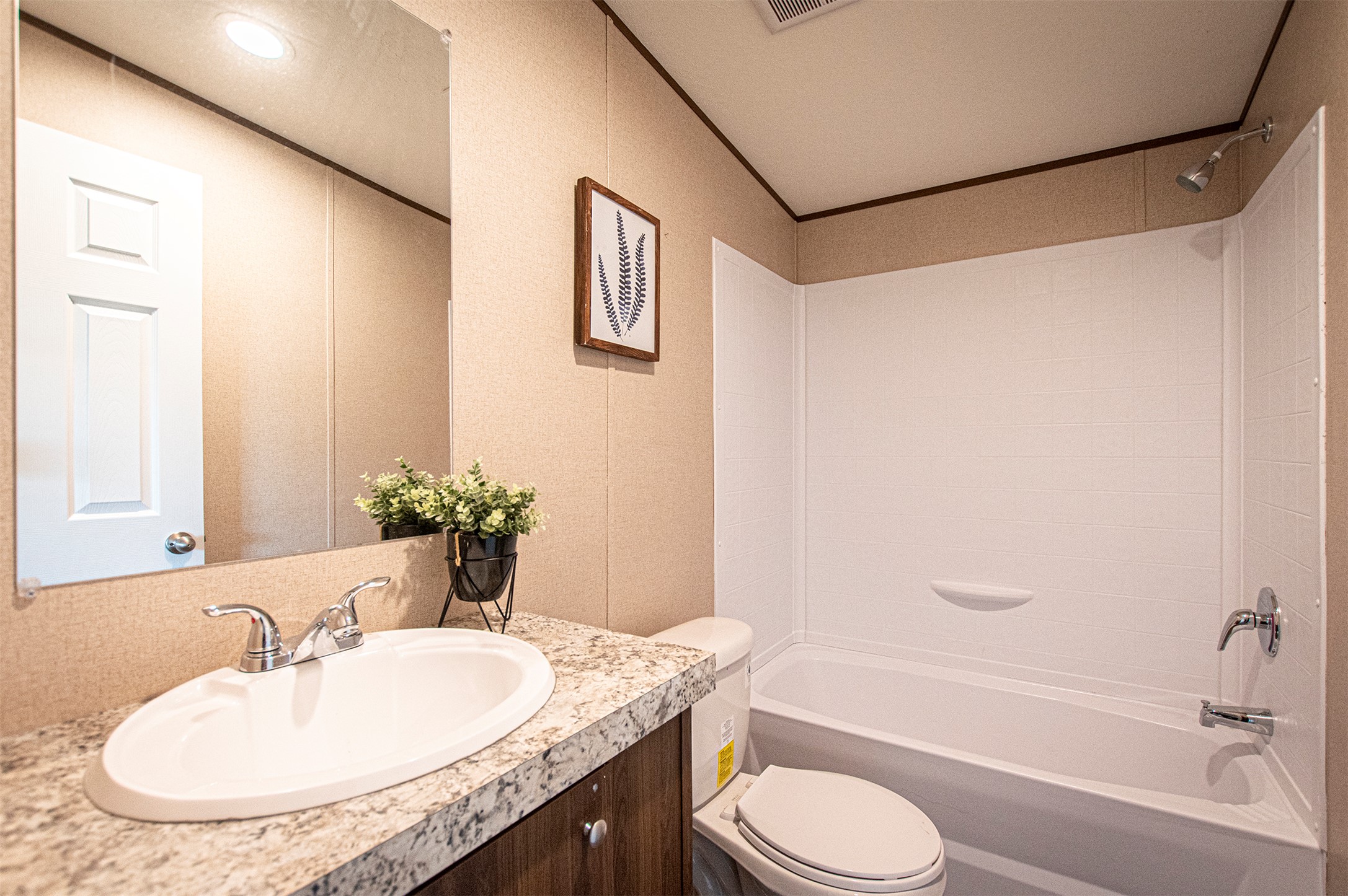 135 Spanish Oak Road Dale, TX 78616 - Photo 21 of 30 a bathroom with a granite countertop sink and a mirror