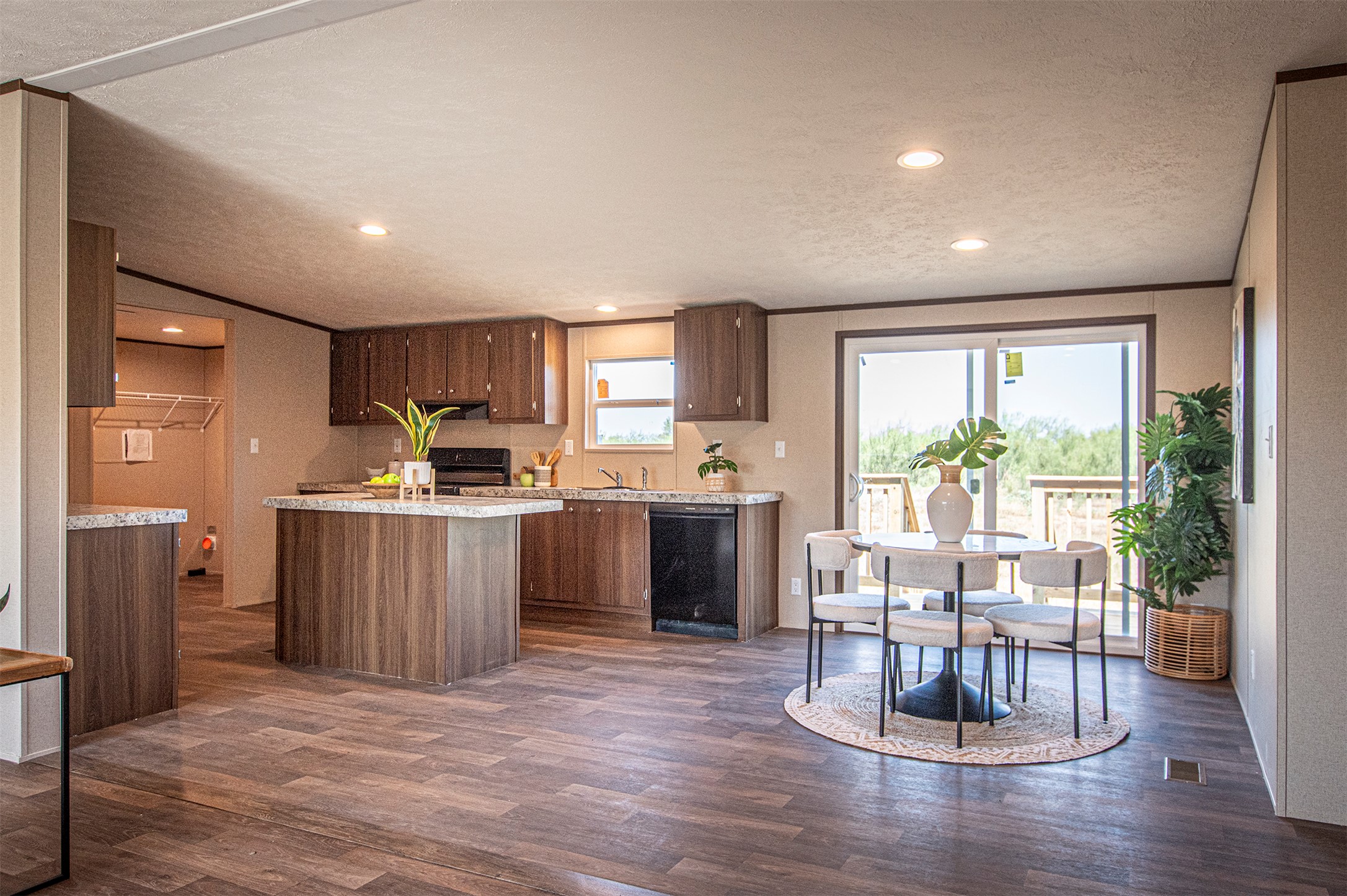 135 Spanish Oak Road Dale, TX 78616 - Photo 10 of 30 a kitchen with a table chairs refrigerator and microwave