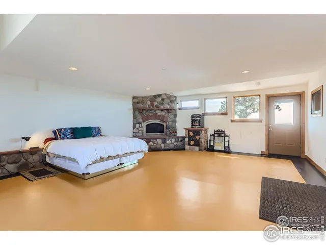 a spacious bedroom with a bed and a large window