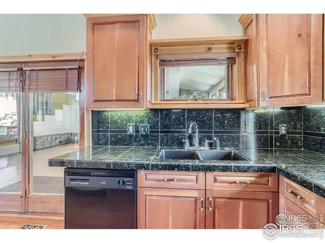 a kitchen with stainless steel appliances granite countertop a sink and cabinets