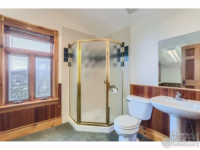 a bathroom with a toilet a sink and a mirror