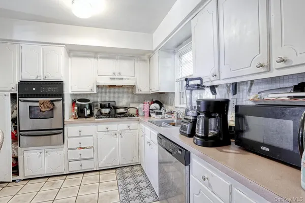 a kitchen with cabinets appliances and a counter space