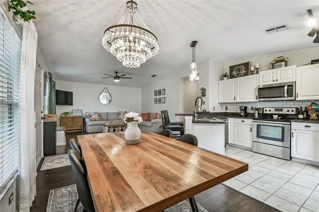 a large kitchen with a table chairs and a stove