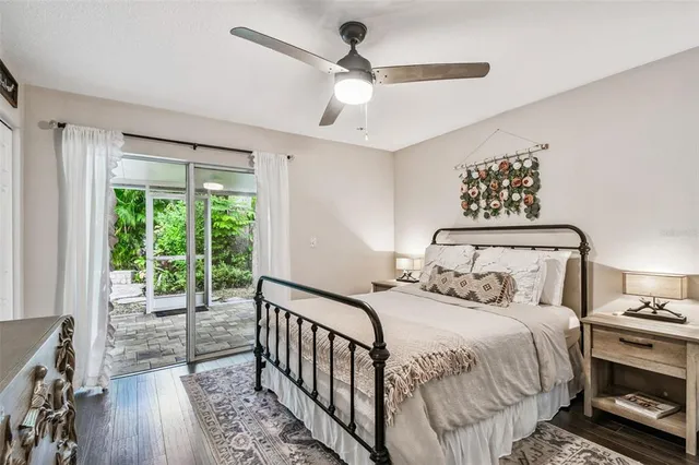 a bedroom with a bed and a large window