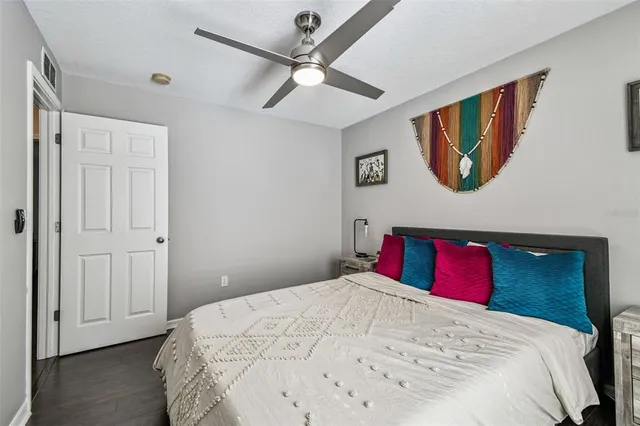 a bedroom with a bed and a painting on the wall