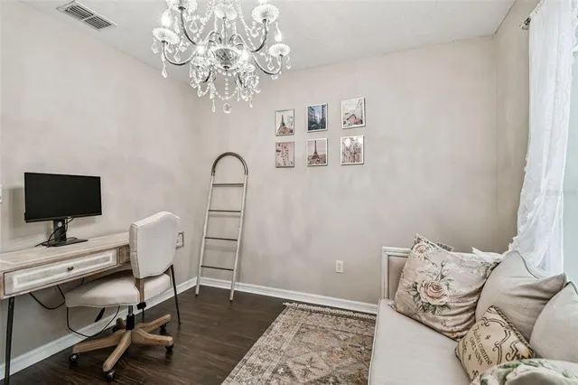 a view of a workspace with furniture and a chandelier