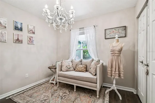 a living room with furniture and a chandelier