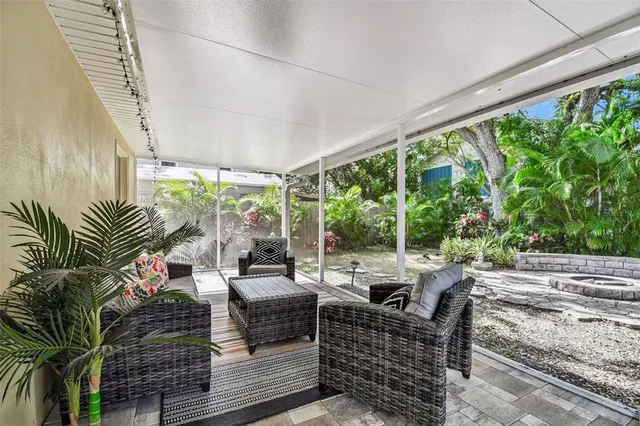 a living room with furniture and a floor to ceiling window