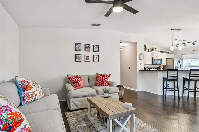 a living room with furniture and wooden floor