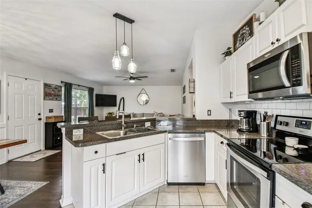 a kitchen with a sink stove and microwave