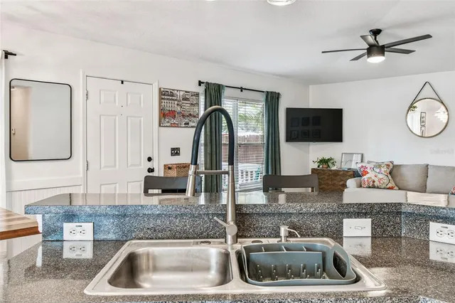 a kitchen with a sink a microwave a stove and cabinets