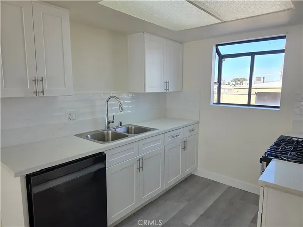 a kitchen with a sink cabinets and window
