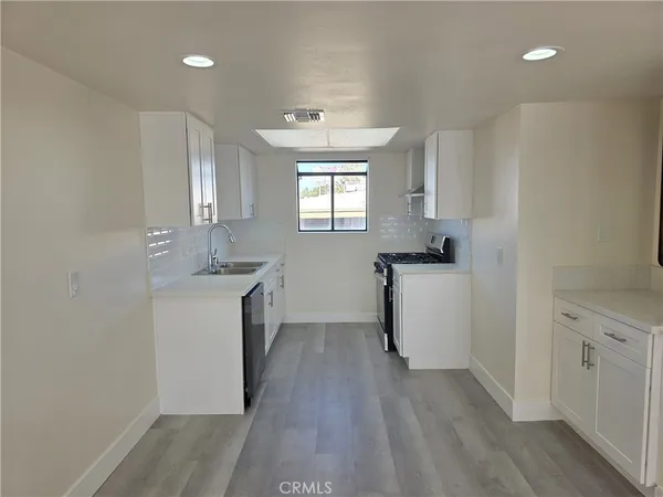 a room with a sink a washer and dryer