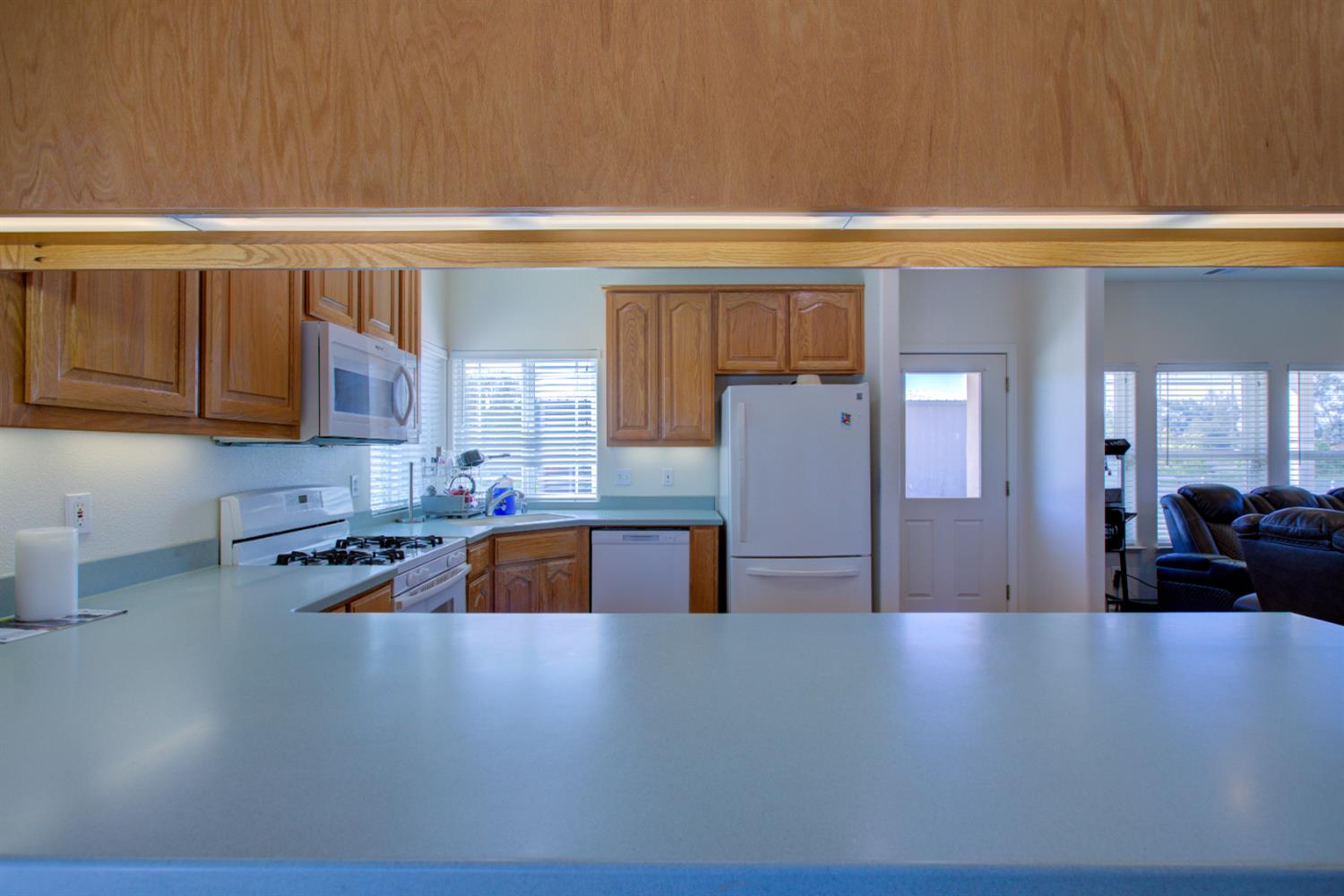 9681 Wamble Road Oakdale, CA 95361 - Photo 11 of 50 a kitchen with a refrigerator and a sink