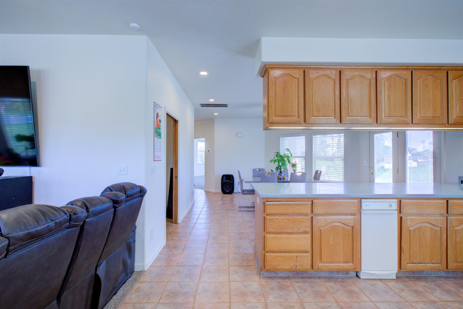 9681 Wamble Road Oakdale, CA 95361 - Photo 12 of 50 a living room with furniture and a flat screen tv