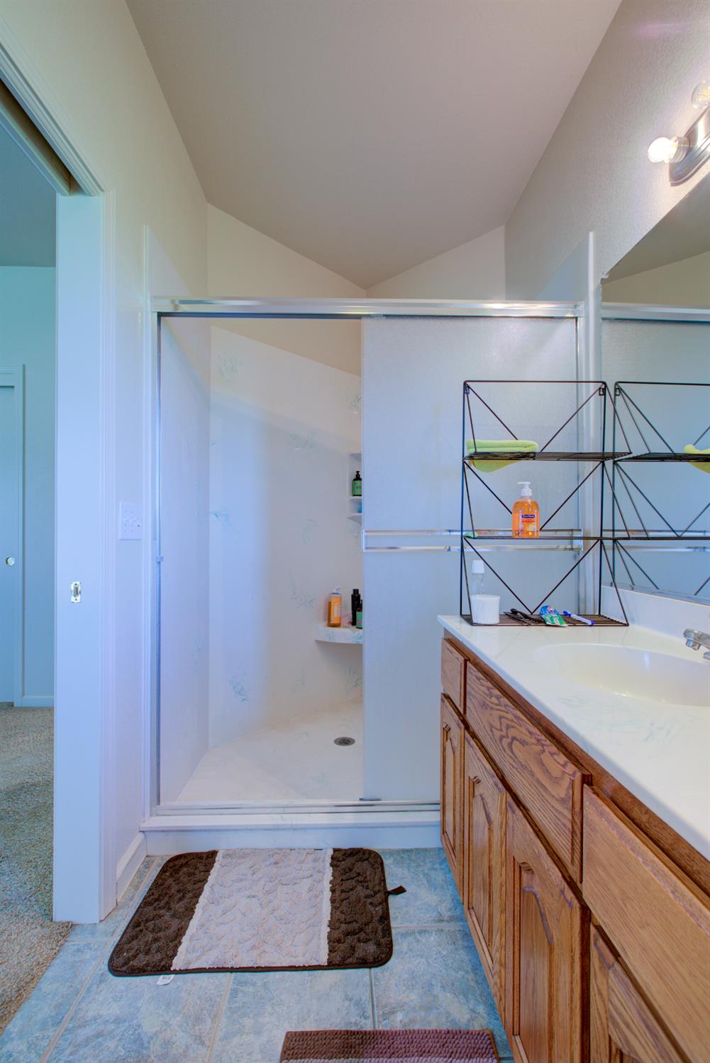 9681 Wamble Road Oakdale, CA 95361 - Photo 15 of 50 a bathroom with a sink and a shower