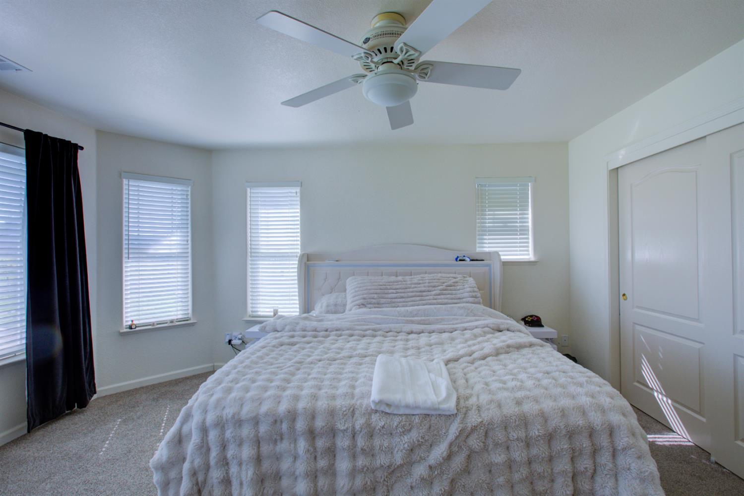 9681 Wamble Road Oakdale, CA 95361 - Photo 16 of 50 a bedroom with a bed and a window