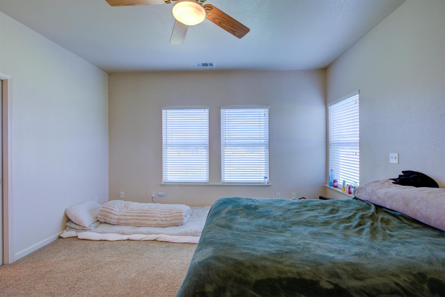 9681 Wamble Road Oakdale, CA 95361 - Photo 20 of 50 a bedroom with a bed and window