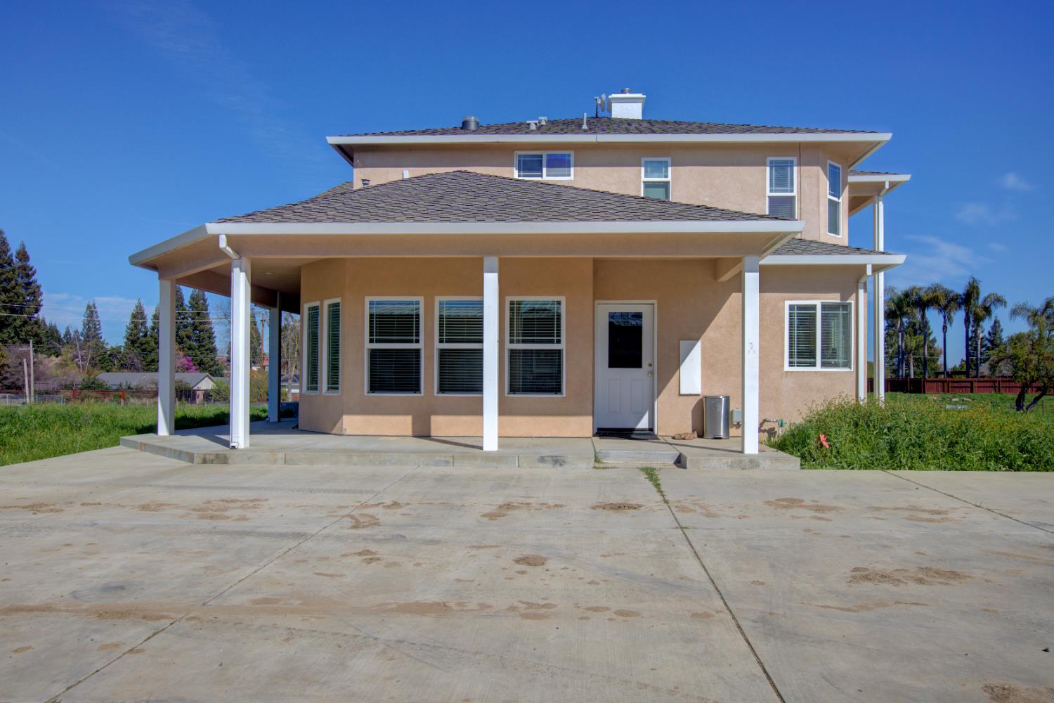 9681 Wamble Road Oakdale, CA 95361 - Photo 2 of 50 a front view of a house with a large window and potted plants
