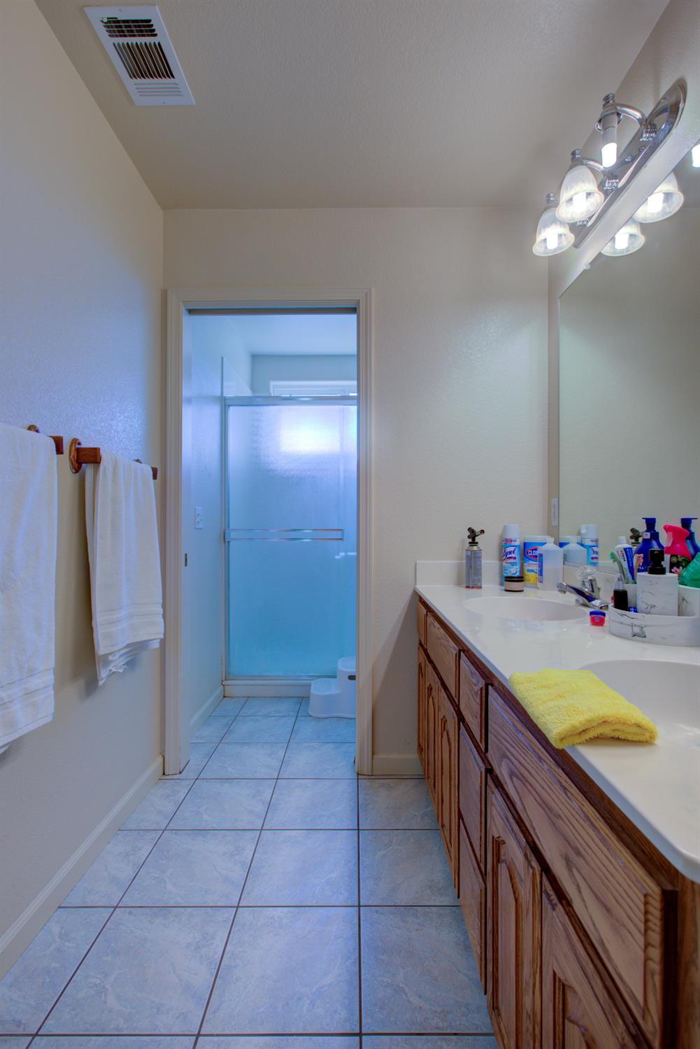 9681 Wamble Road Oakdale, CA 95361 - Photo 30 of 50 a bathroom with a tub sink and mirror