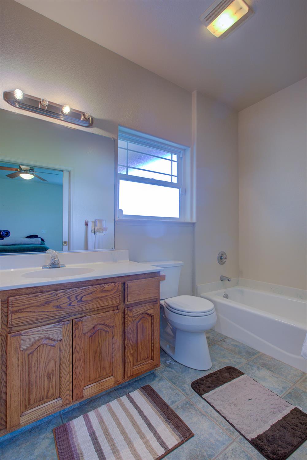 9681 Wamble Road Oakdale, CA 95361 - Photo 33 of 50 a bathroom with a toilet a sink and bathtub