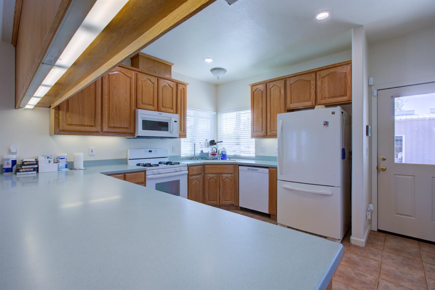 9681 Wamble Road Oakdale, CA 95361 - Photo 34 of 50 a kitchen with stainless steel appliances granite countertop a refrigerator a stove top oven a sink and dishwasher
