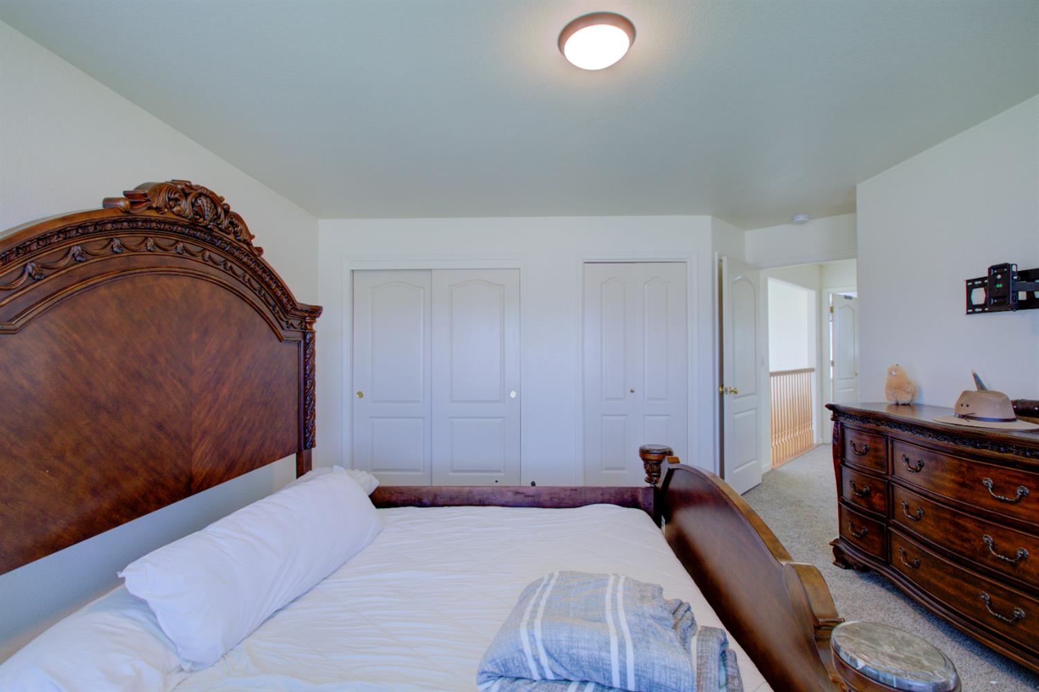 9681 Wamble Road Oakdale, CA 95361 - Photo 41 of 50 a bedroom with a bed and wooden floor