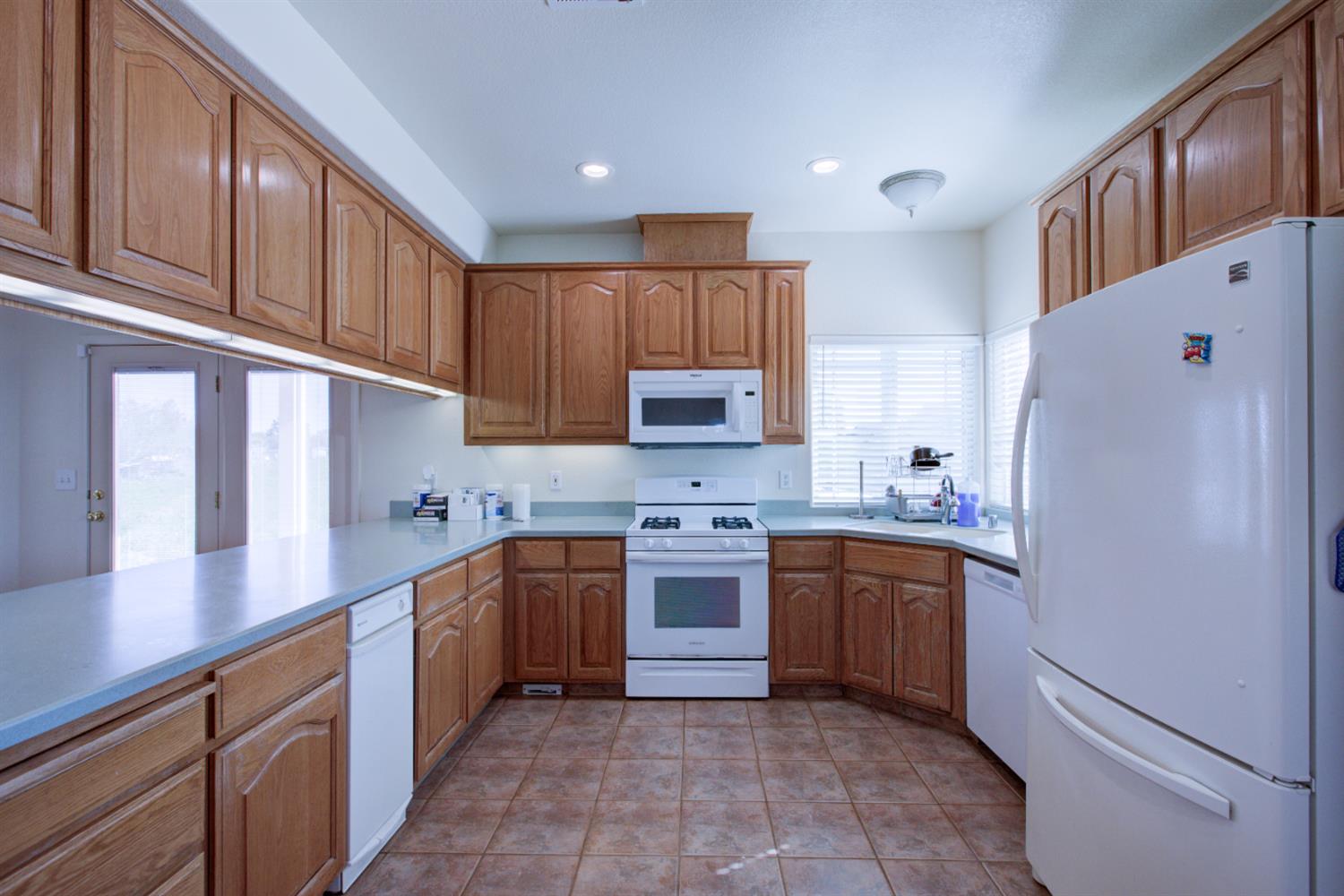 9681 Wamble Road Oakdale, CA 95361 - Photo 7 of 50 a kitchen with stainless steel appliances granite countertop a refrigerator sink and cabinets