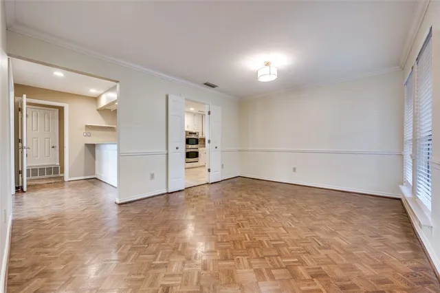 a kitchen with white cabinets white stainless steel appliances and refrigerator