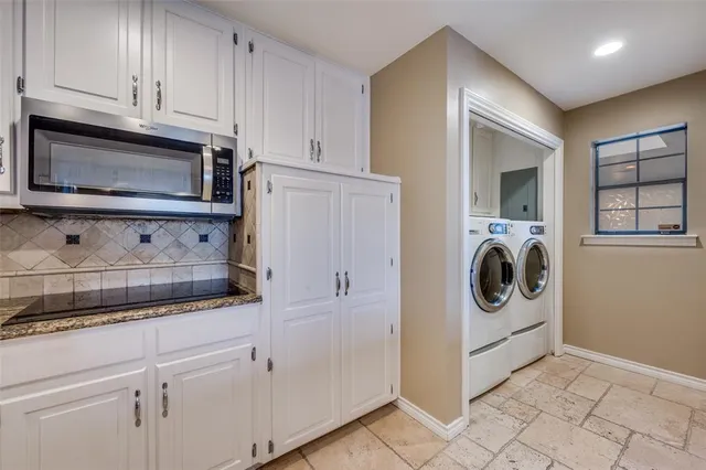 a kitchen with granite countertop a sink and cabinets