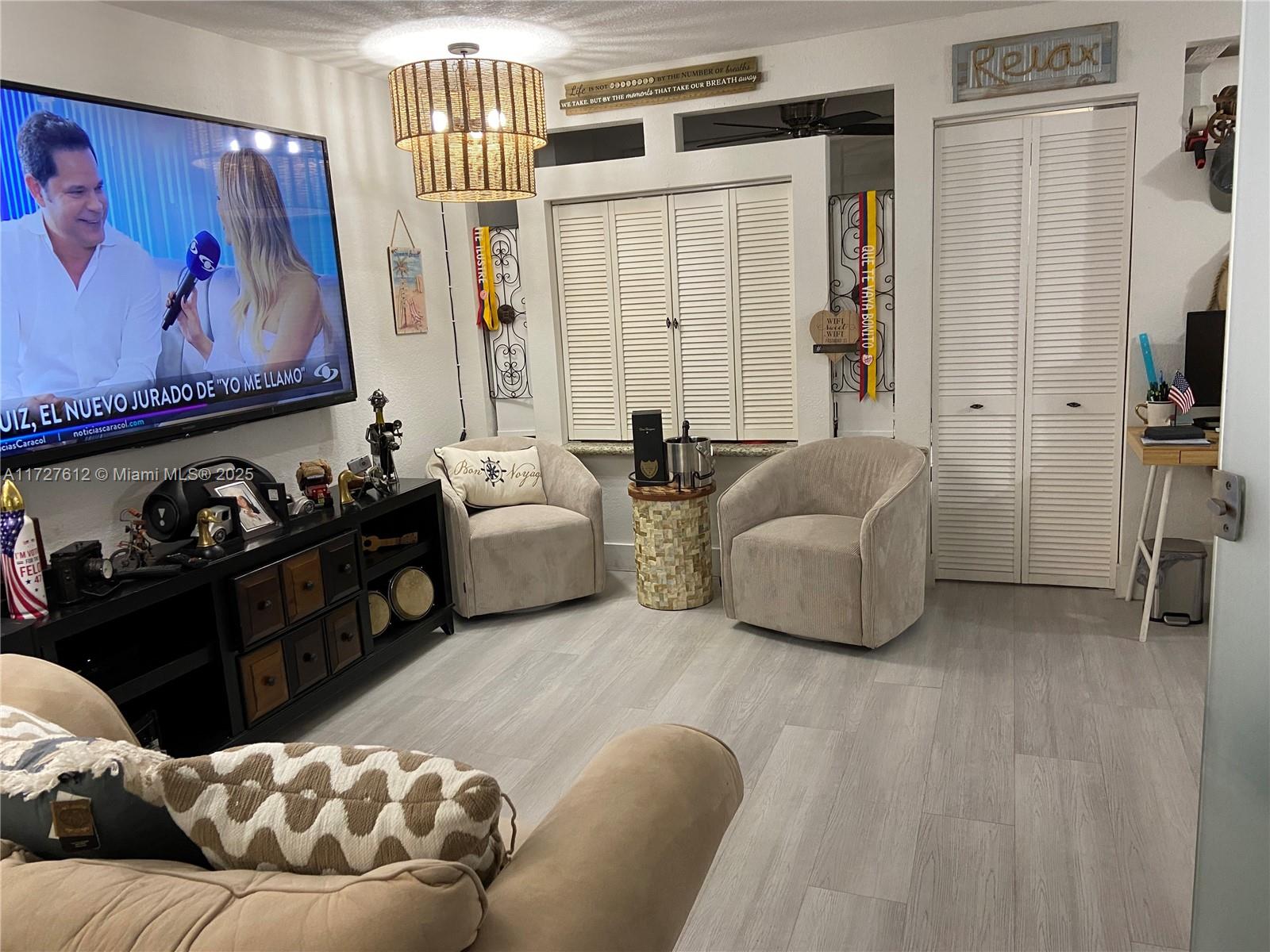 17021 North Bay Road, Unit 627 Sunny Isles Beach, FL 33160 - Photo 11 of 24 a living room with furniture and a flat screen tv