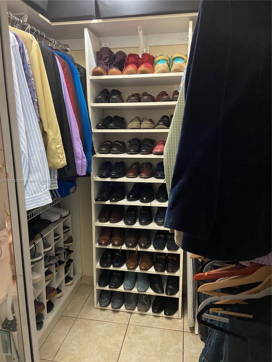 17021 North Bay Road, Unit 627 Sunny Isles Beach, FL 33160 - Photo 14 of 24 a view of walk in closet with clothes and shoes