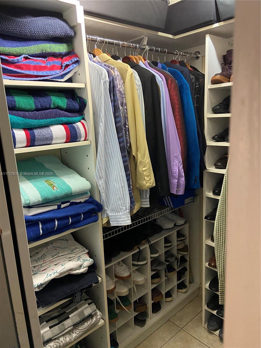 17021 North Bay Road, Unit 627 Sunny Isles Beach, FL 33160 - Photo 15 of 24 a view of walk in closet with clothes and shoes