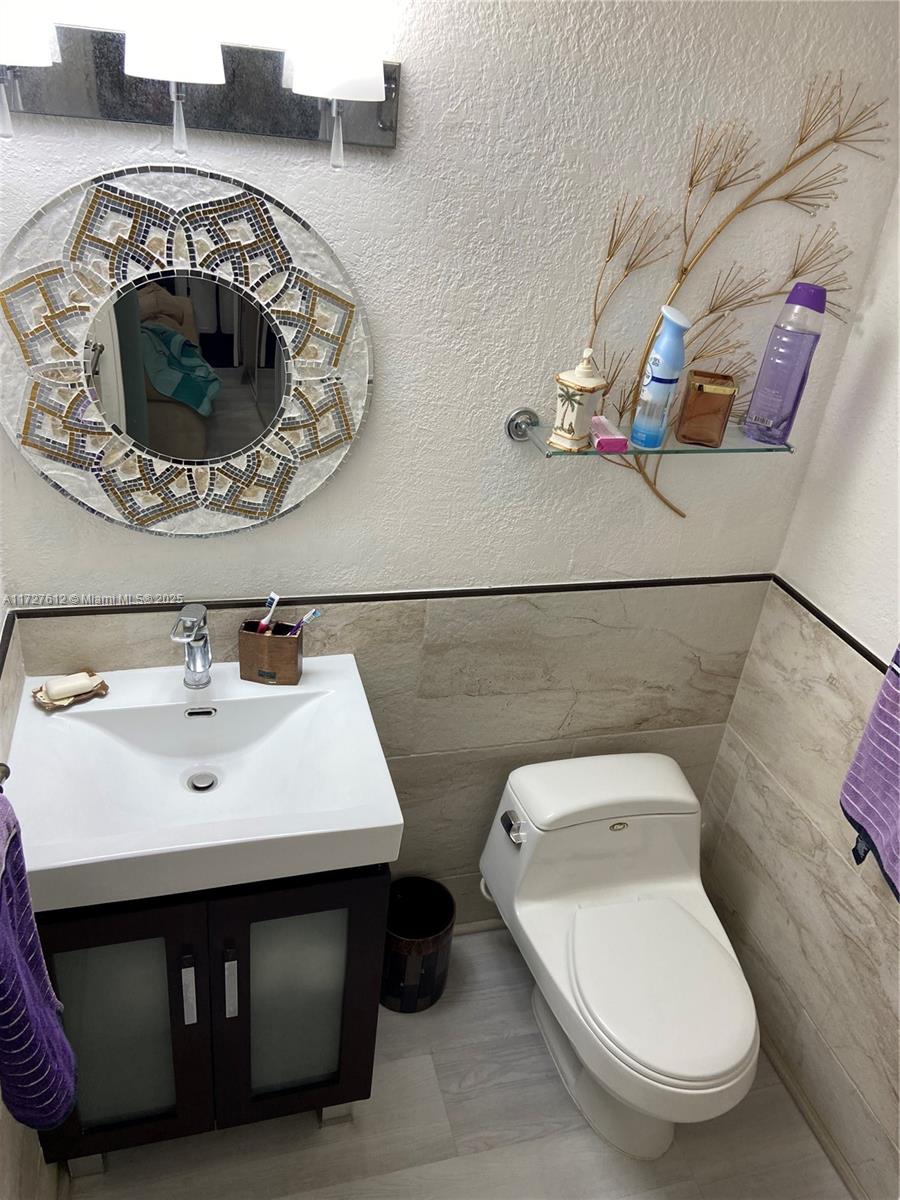 17021 North Bay Road, Unit 627 Sunny Isles Beach, FL 33160 - Photo 16 of 24 a bathroom with a sink a toilet and a mirror