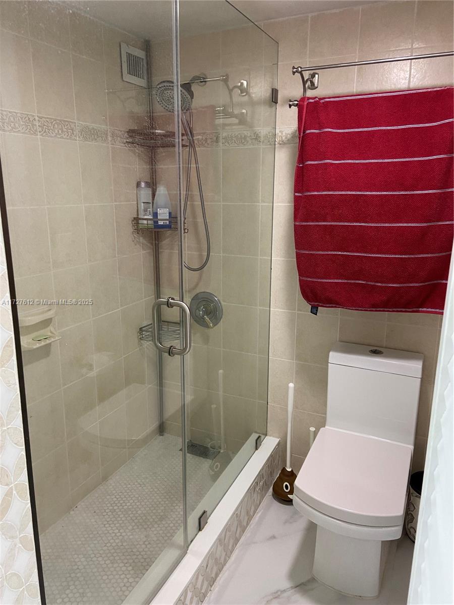 17021 North Bay Road, Unit 627 Sunny Isles Beach, FL 33160 - Photo 17 of 24 a bathroom with a toilet and a shower